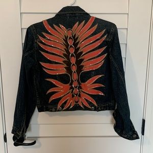 Vintage denim jacket with custom patch on back.